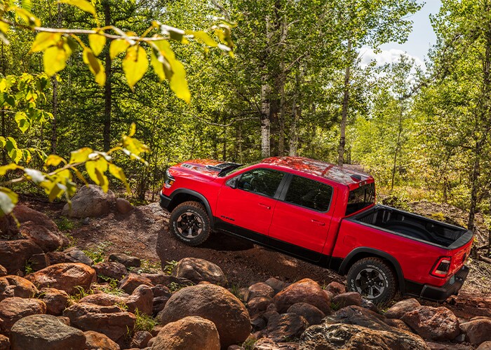 red Ram 1500 truck bouldering up a wooded hill