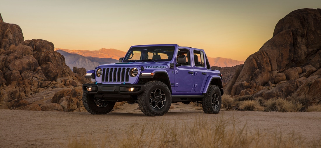 2023-Jeep-Wrangler-Unlimited-Rubicon-4xe-SUV-L15.png purple Jeep Wrangler Unlimited 4xe parked in a desert scene