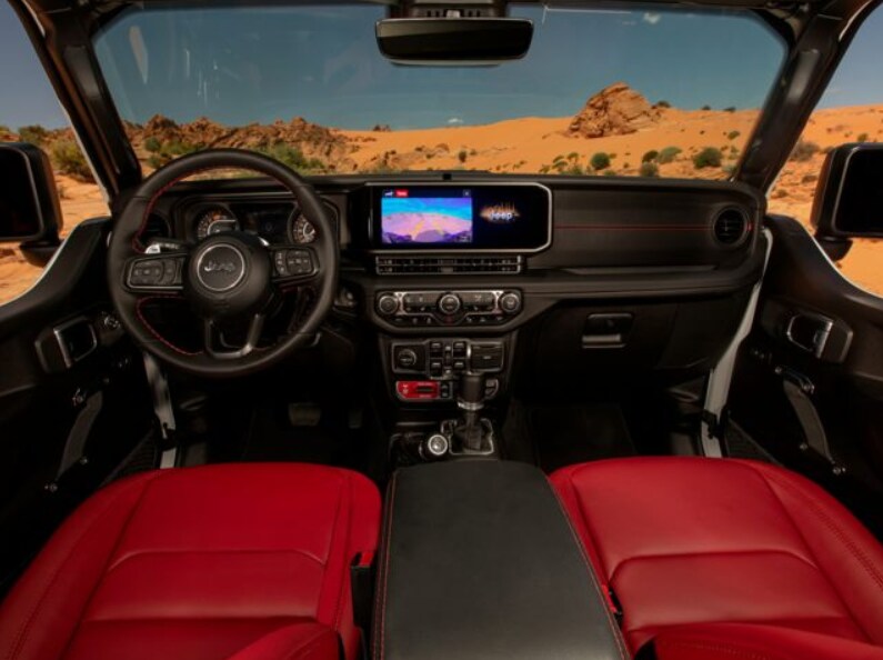 2024 Jeep Wrangler Rubicon 392 Interior Front Steering.png red and black leather interior front seats, steering, and infotainment
