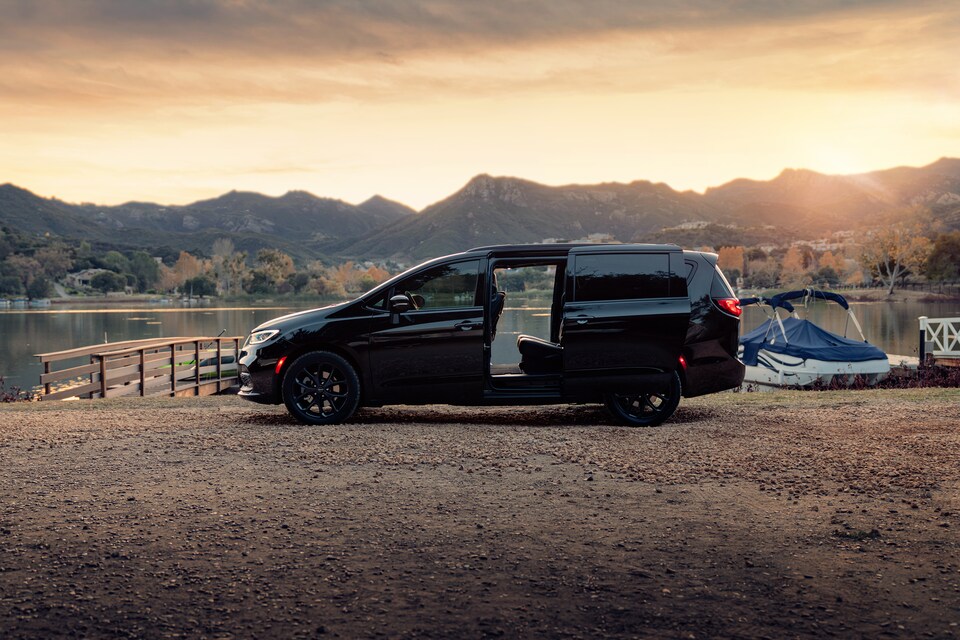 2021-Chrysler-Pacifica-LimitedS-Van-L04.png black Chrysler Pacifica parked at sunset with the sliding doors open