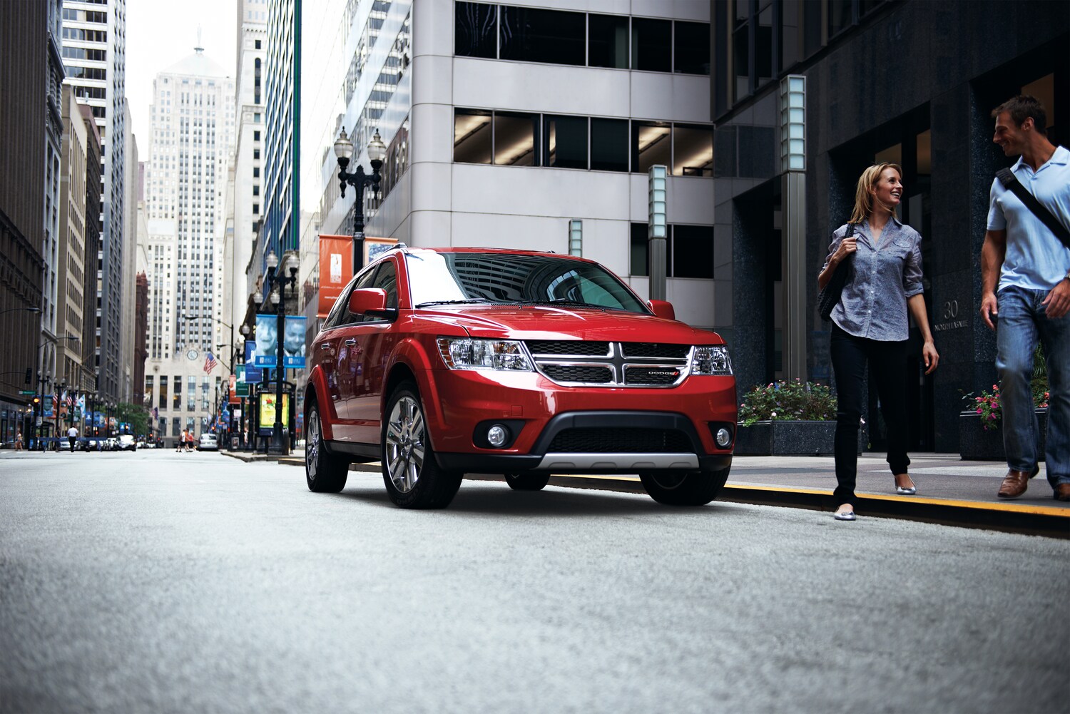 2021-Dodge-Journey-SE-SUV-L01.png red Dodge Journey SUV parked on a city street