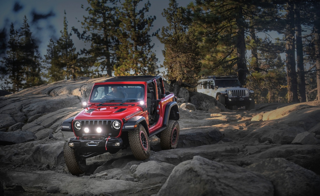 Jeep-Lifestyle-12.png lifted Red Jeep Wrangler bouldering down a hillside