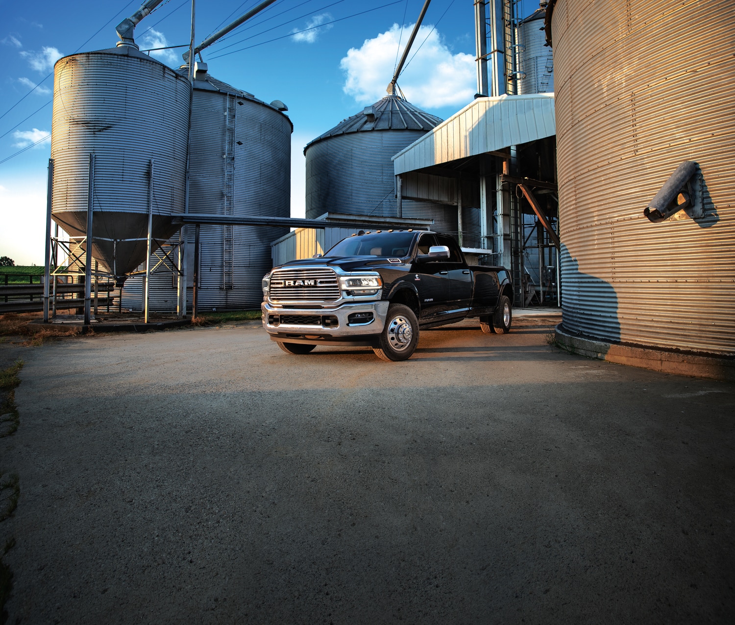 2021-RAM-3500-Laramie-CrewCab-Dually-Truck-L01.png black Ram 3500 commercial truck at a grain silo