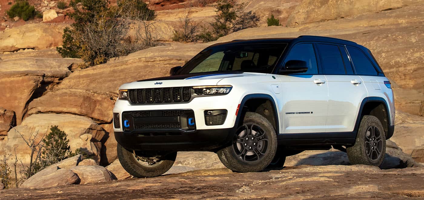 white Jeep Grand Cherokee 4xe parked in a desert