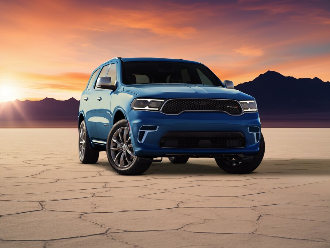 2025 Durango blue Dodge Durango parked in the desert at sunset