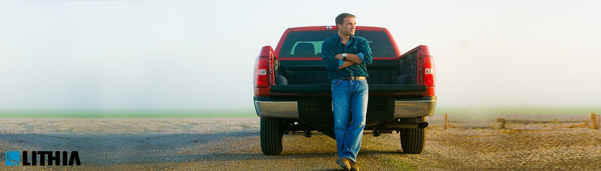 Best Mid-Size Pickup Trucks Man leaning on bed of truck