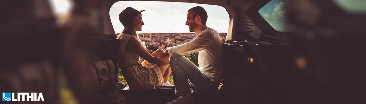 Ultimate Guide to a Good Car Lease Woman and Man camping in backseat of suv