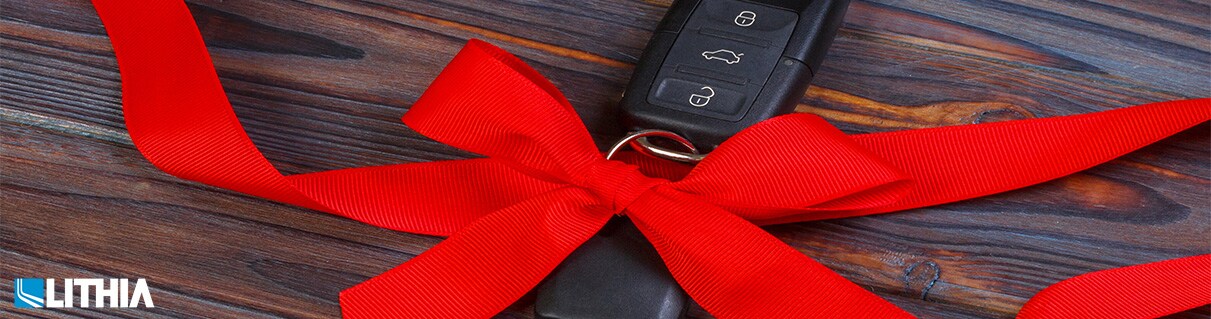 How to Give a Car as a Gift High Angle View Of Keys with Red Ribbon on Wooden Table