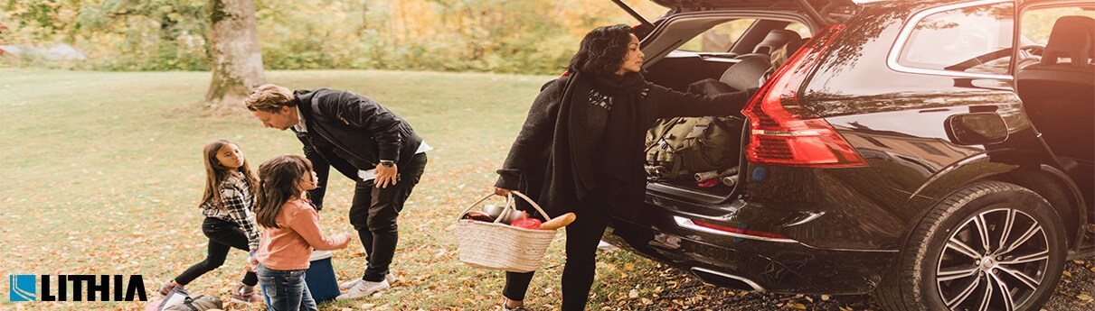 Top 5 Family Cars Family getting ready for a trip loading up SUV