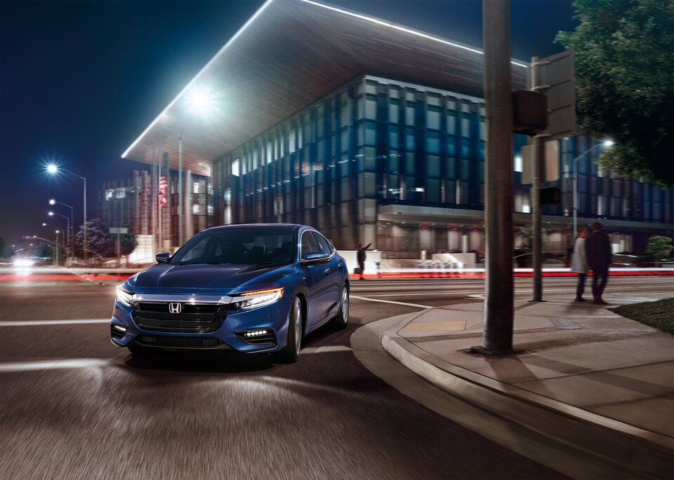 2019-Honda-InsightHybrid-Touring-Sedan.png blue Honda Insight hybrid sedan turning a corner in a busy city at night