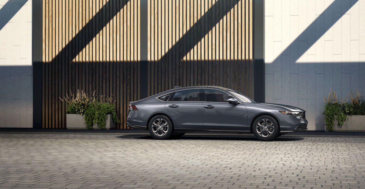 dark grey Honda Accord parked next to a hotel