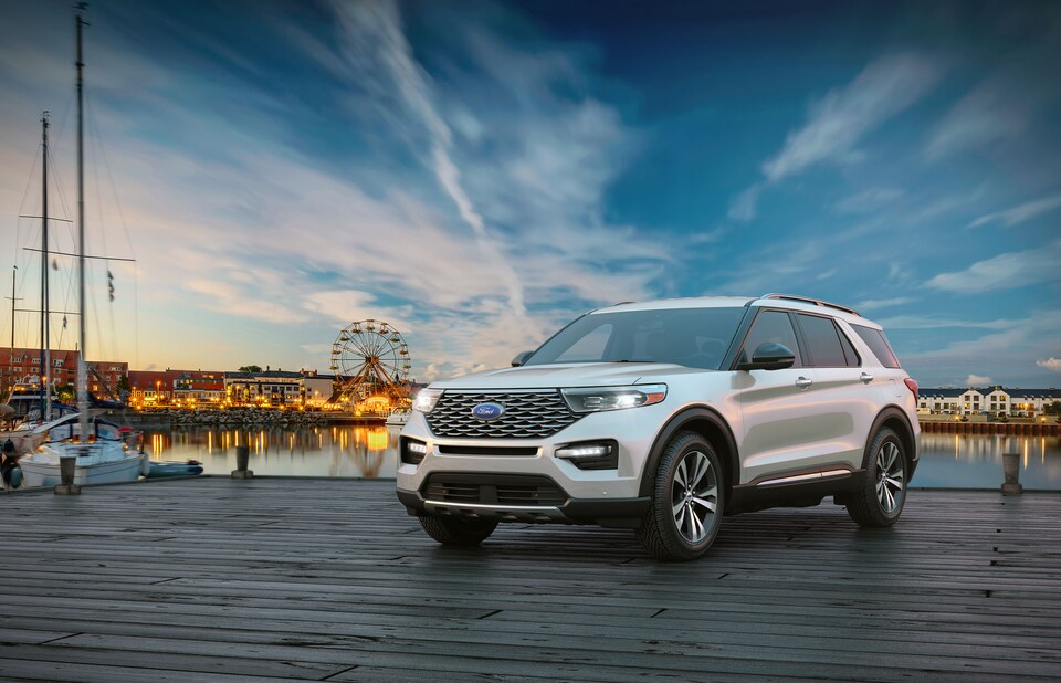 2020-Ford-Explorer-Platinum-SUV-L08.png white Ford Explorer SUV parked at a pier fairground