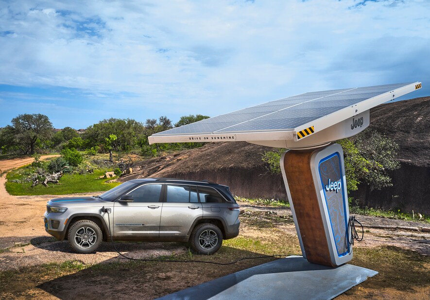 2022-Jeep-GrandCherokeeWL-4xe-Trailhawk-SUV-L12.png Jeep Grand Cherokee 4xe hybrid SUV parked at a Jeep charging station