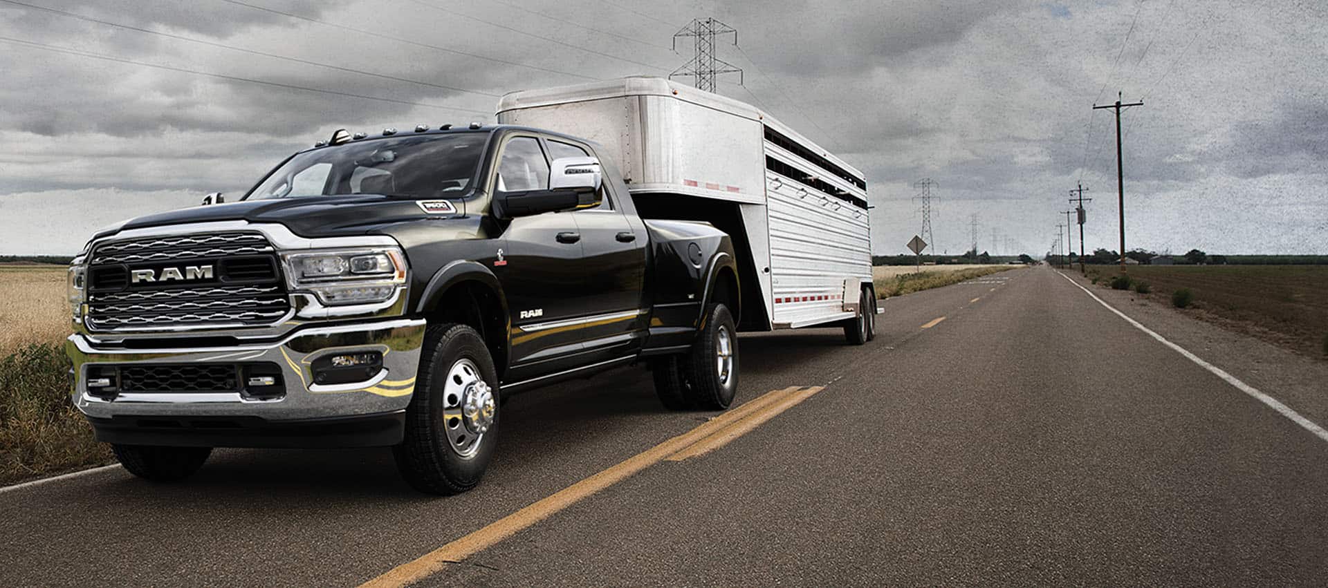 black Ram 3500 truck towing a horse trailer