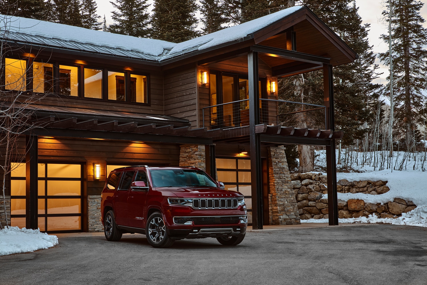 2022-Jeep-Wagoneer-SeriesII-SUV-L17.png dark red Jeep Wagoneer luxury SUV parked in front of a snowy ski lodge