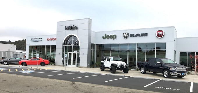Lithia Chrysler Dodge Jeep Ram FIAT of Roseburg Lithia Chrysler Dodge Jeep Ram FIAT of Roseburg dealership with cars parked in front.