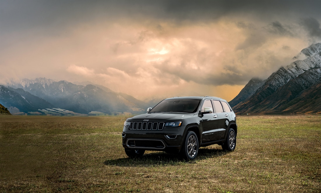 2022-Jeep-GrandCherokeeWK-Limited-SUV-L01.png black Jeep Grand Cherokee SUV parked on a flat field among a mountain range