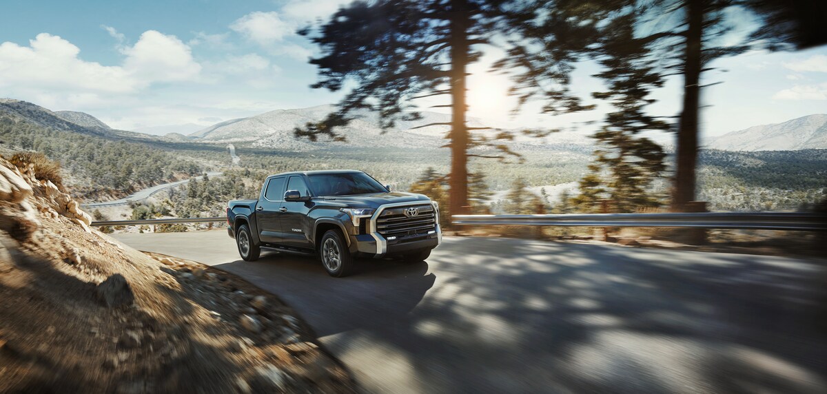 2022-Toyota-Tundra-Limited-CrewCab-Truck-L01.png black Toyota Tundra driving up a steep mountain road