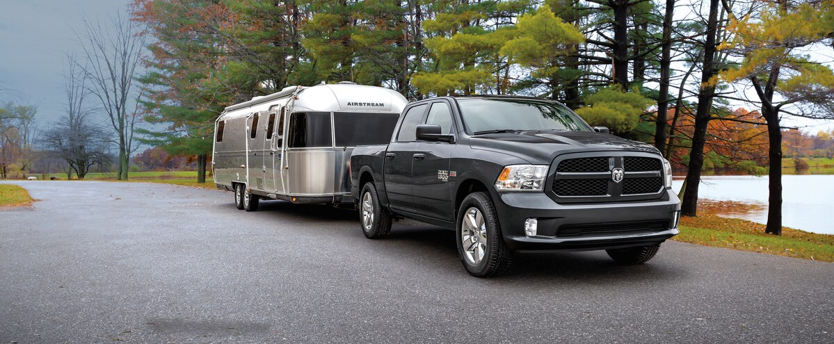 2022-RAM-1500-Classic-Express-CrewCab-Truck.png black Ram 1500 truck towing an airstream trailer