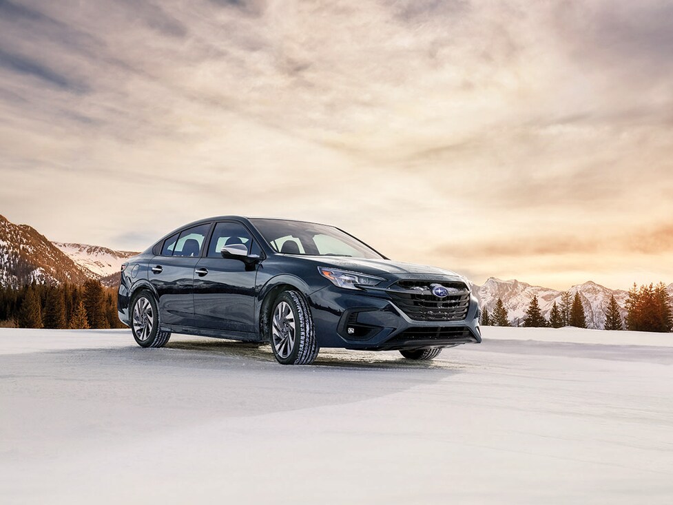 2023-Subaru-Legacy-Touring-SUV.png blue Subaru Legacy SUV parked on a snowy field