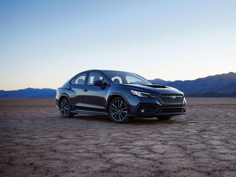 2023-Subaru-WRX-Limited-Sedan.png black Subaru WRX sports sedan parked in the desert
