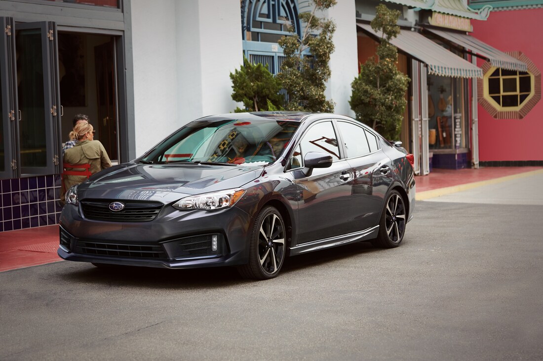 2021-Subaru-Impreza-Sport-Sedan-L02.png grey Subaru Impreza car parked in front of a restaurant