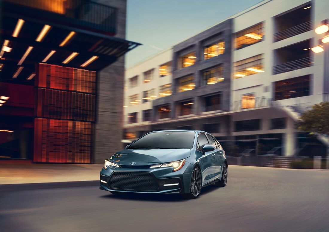 2021-Toyota-Corolla-XSE-Sedan-L08.png dark teal Toyota Corolla driving fast through city streets