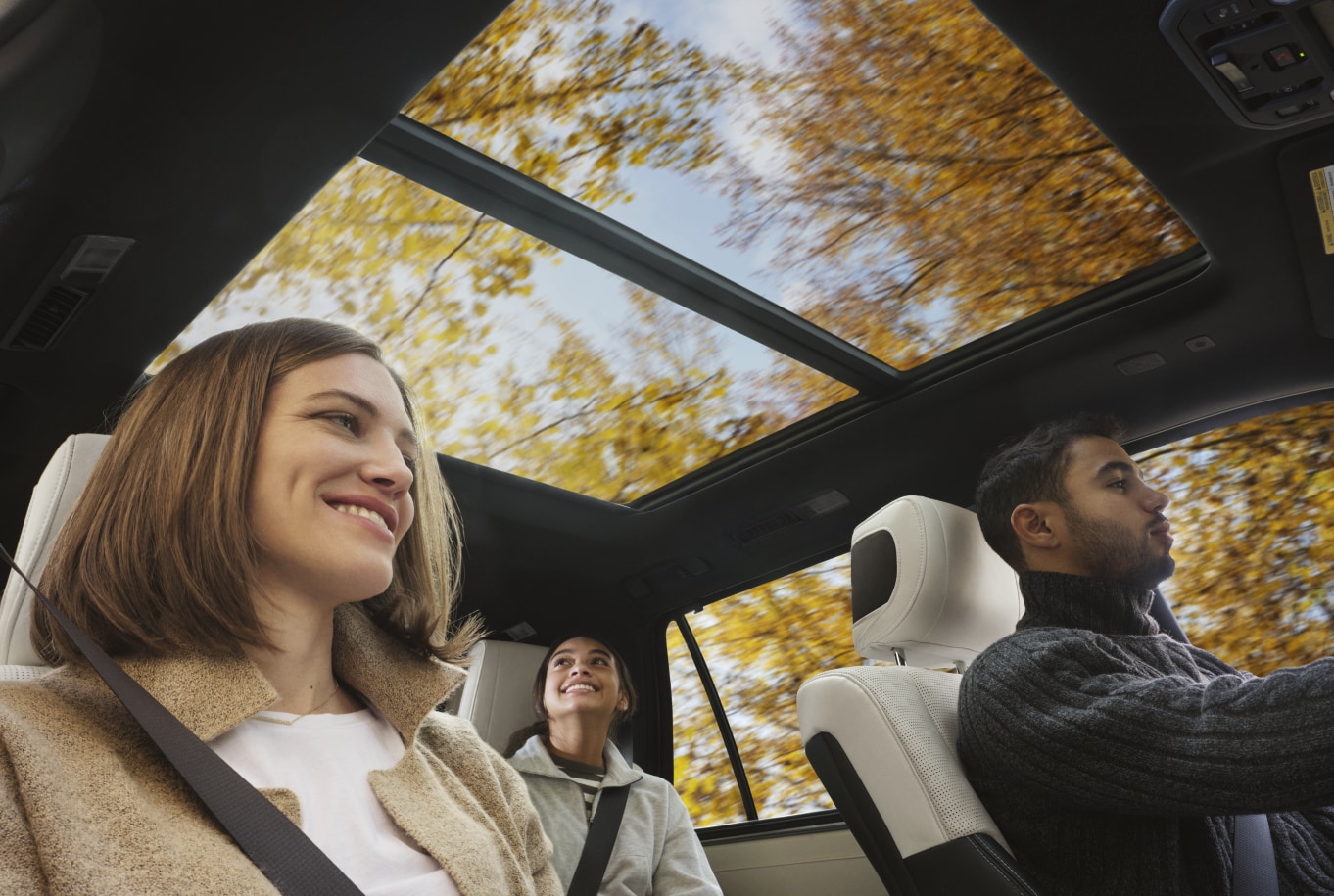 2022 Toyota Sequoia Moonroof.png family driving a Toyota Sequoia on a Fall day, large moonroof featured