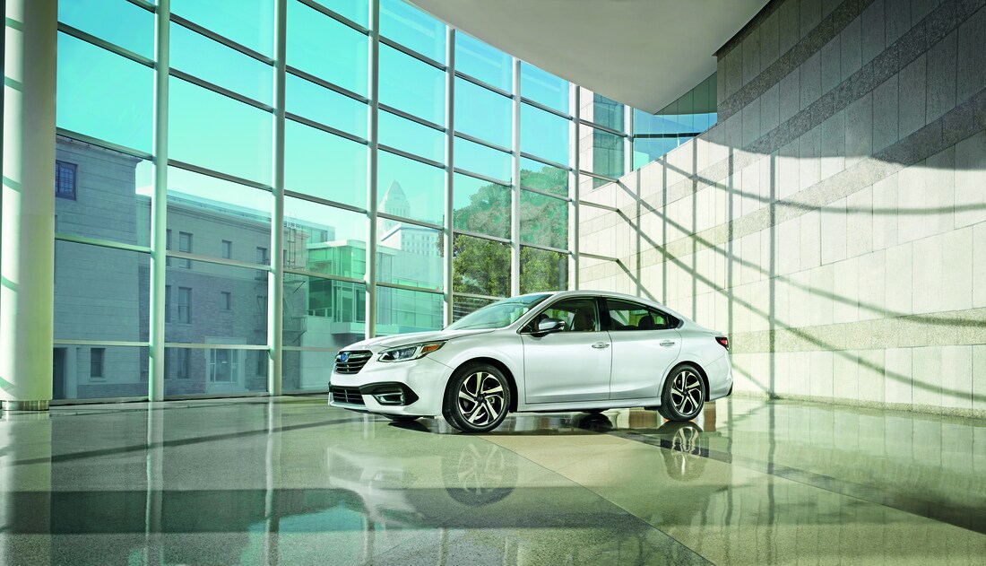 2021-Subaru-Legacy-TouringXT-Sedan-L01.png blue Subaru Legacy sedan driving through city streets