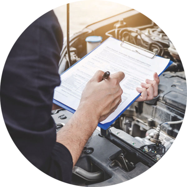 Vehicle Inspection A person standing over an engine with a clip board and pen.