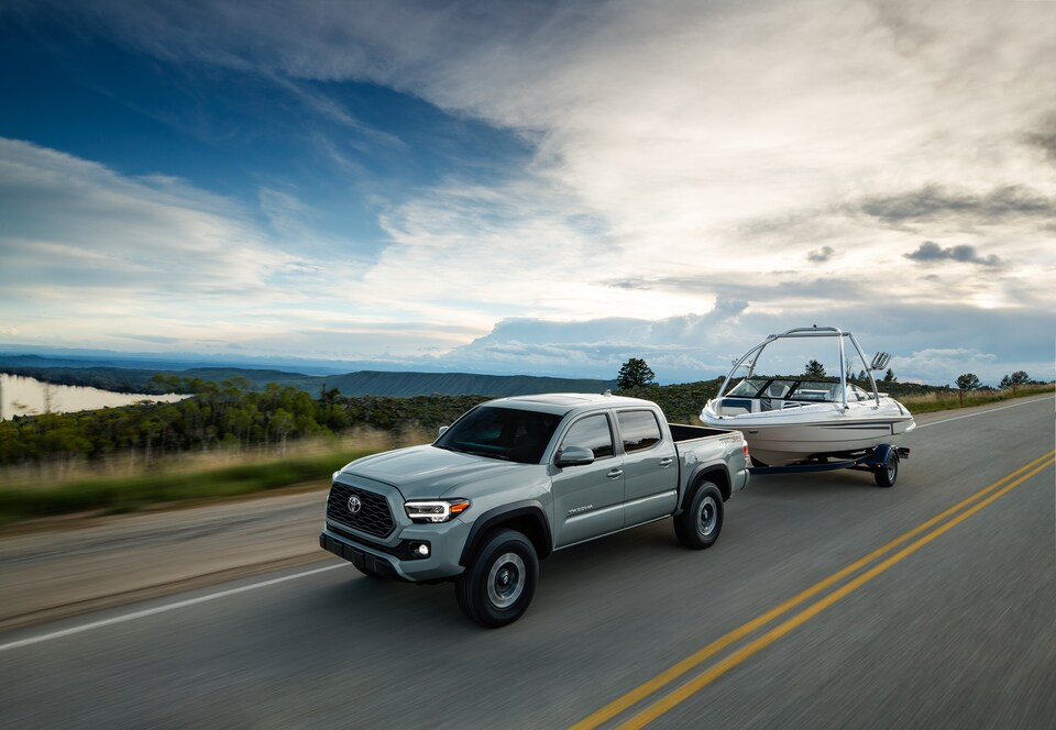 2022-Toyota-Tacoma-TRDOffRoad-DoubleCab-Truck-L04.png silver Toyota Tacoma truck towing a boat