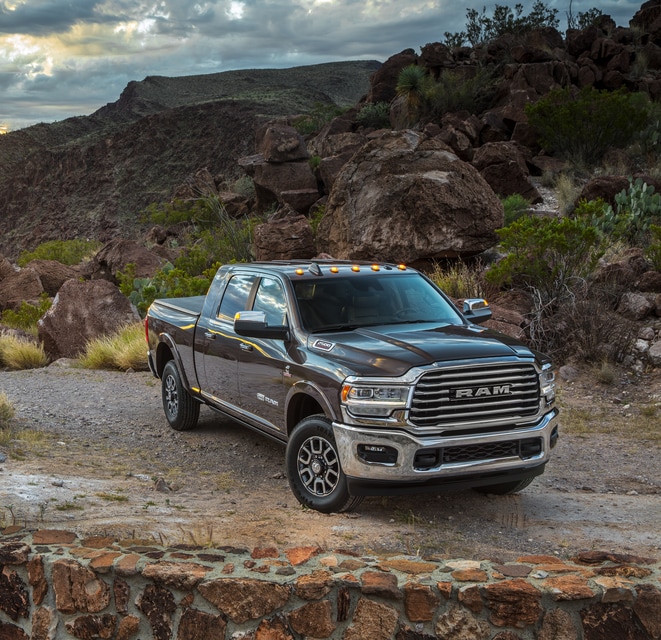 2021-RAM-2500-LaramieLonghorn-MegaCab-Truck-L08 (2).png brown Ram 2500 heavy duty truck parked on a desert ledge
