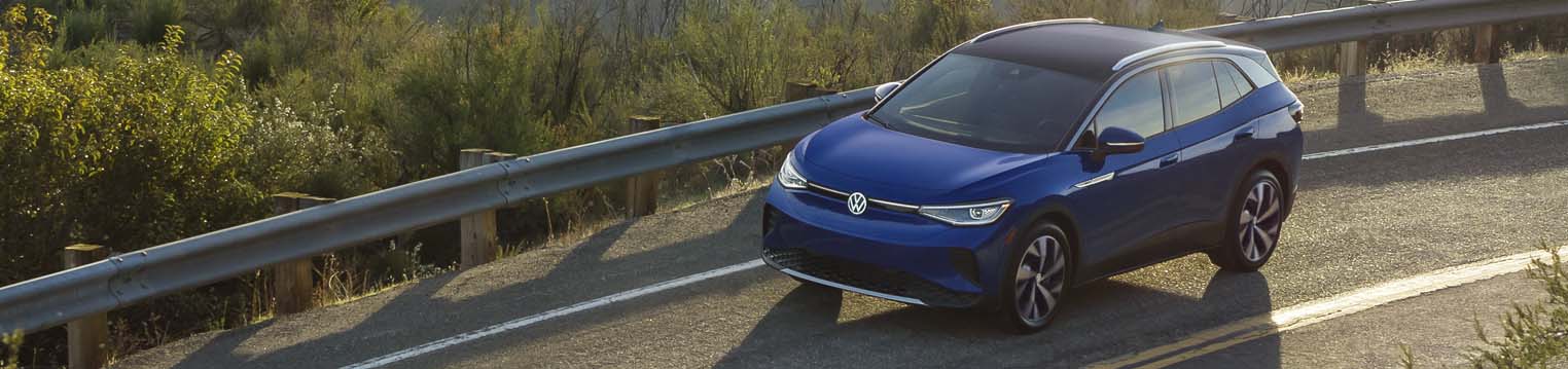 2021 Volkswagen ID.4 Electric Vehicle A 2021 Volkswagen ID.4 Electric Vehicle driving on a road in a green valley.