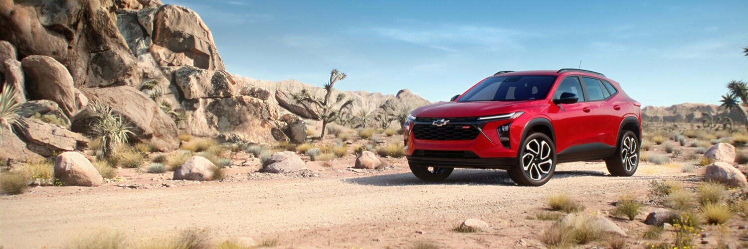 2025 Chevy Trax Red 2025 Chevrolet Trax parked on a desert road next to mountain terrain and cacti