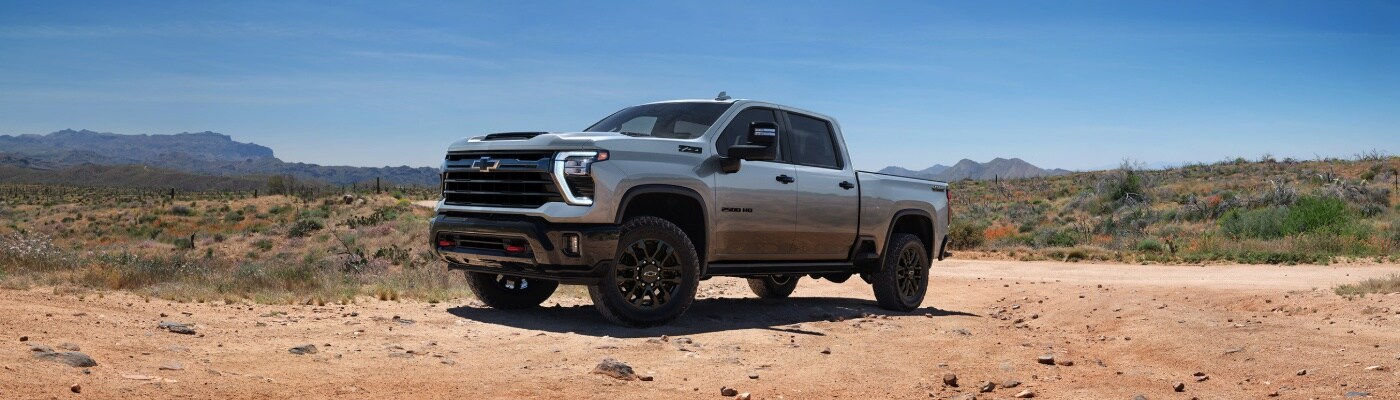 2025 Chevy Silverado 2500 2025 Chevrolet Silverado 2500 Trail Boss Crew Cab Short Bed truck parked in rocky desert dirt road