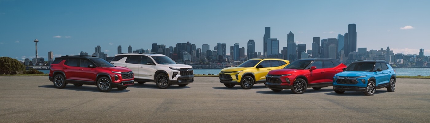 Chevy Truck Lineup Chevy Truck Lineup of trucks
parked together next to a mountain