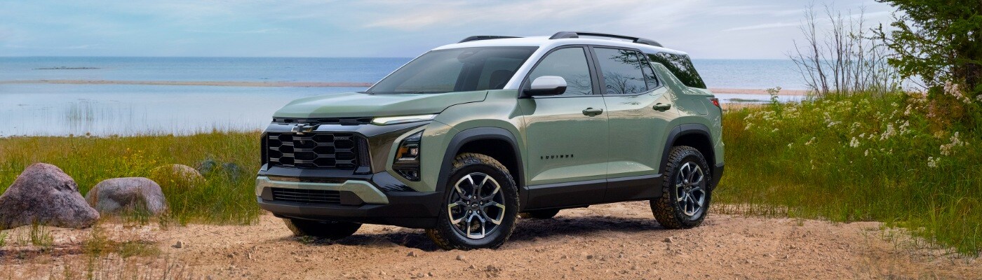 2025 Chevy Equinox Green Chevy Activ parked next to large lake