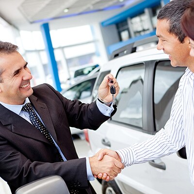 Customers buying a vehicle from a salesman