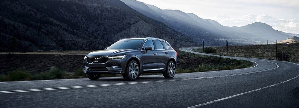 2018 Volvo XC60 driving by mountains