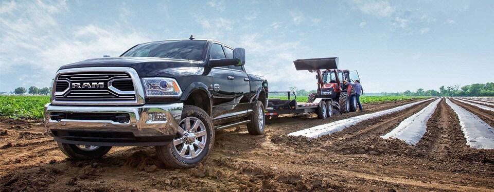 2018 RAM 2500 towing a tractor