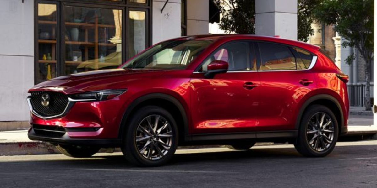 2021 Mazda CX-5 SUV Touring red parked by shop with awning_res.jpg