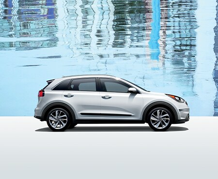 White Kia Niro on blue background