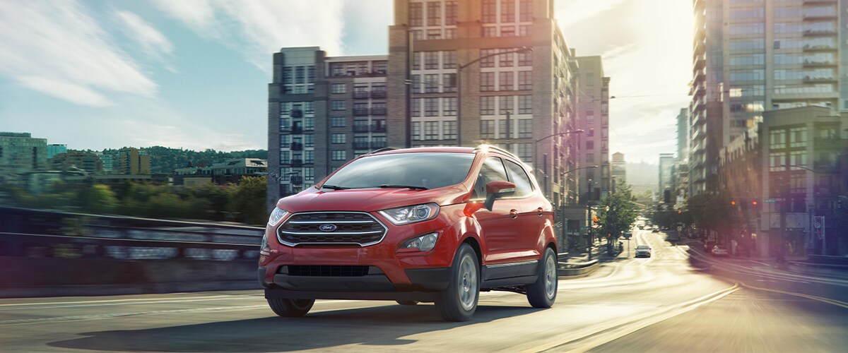 Red Ford EcoSport driving through a city