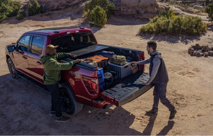 Man unloading his gear from his ford truck