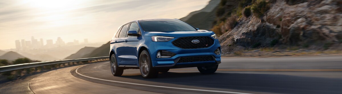20_FRD_EDG_43252_Fade.jpg New Ford Edge driving on a hilltop street