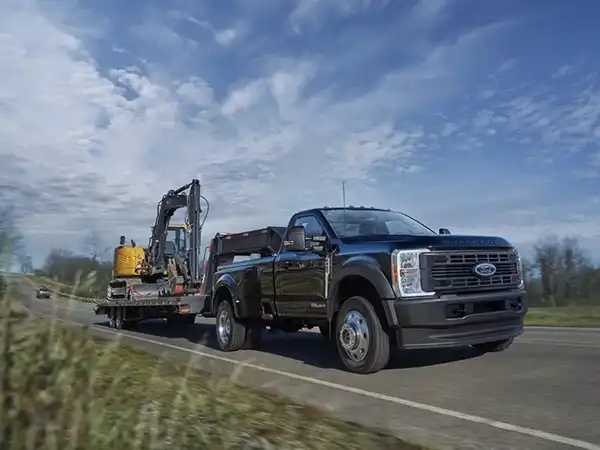 2025 Ford Super Duty towing a escavator