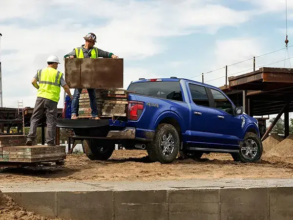 2026 Ford F-150 view of men loading pallets into bed of truck