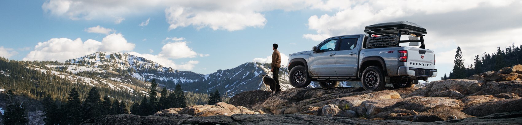2022 Nissan Frontier white parked on boulder overlooking scenic vista.jpg
