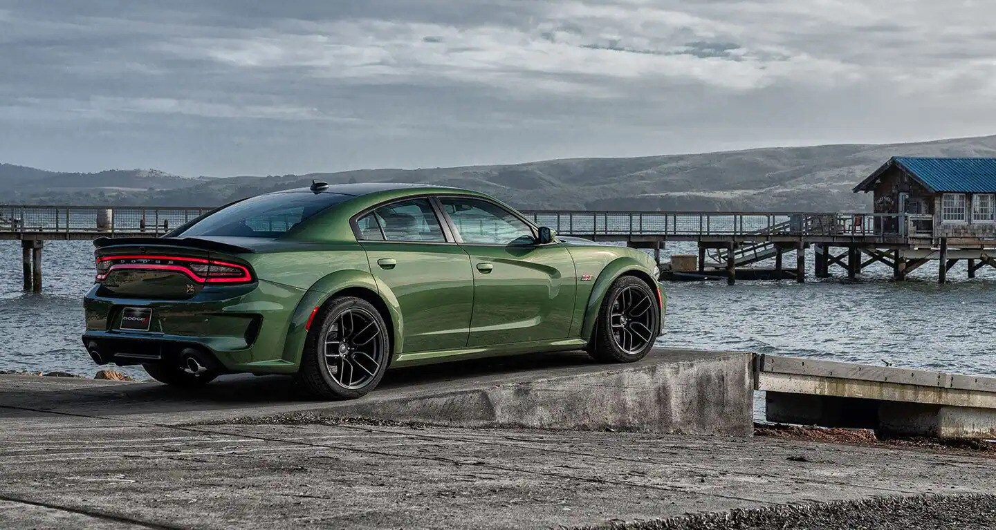 Brand new 2022 Dodge Charger available today at Jubilee Chrysler Dodge Jeep Ram Dodge Charger parked on a dock with water in the background