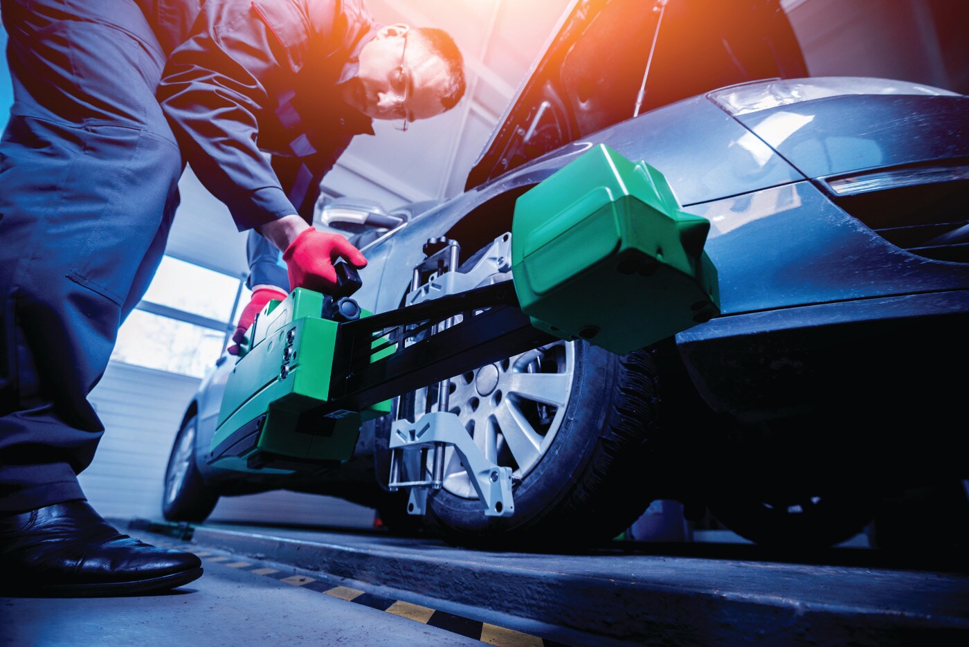 man fixing wheel on a car